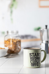 Mug of morning coffee on white tile tabletop in kitchen. Healthy breakfast consept with coffee and muesli. Text space