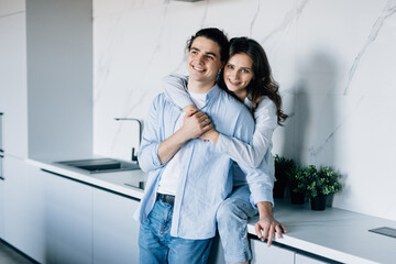 Young Couple in love hugging and using tablet together.