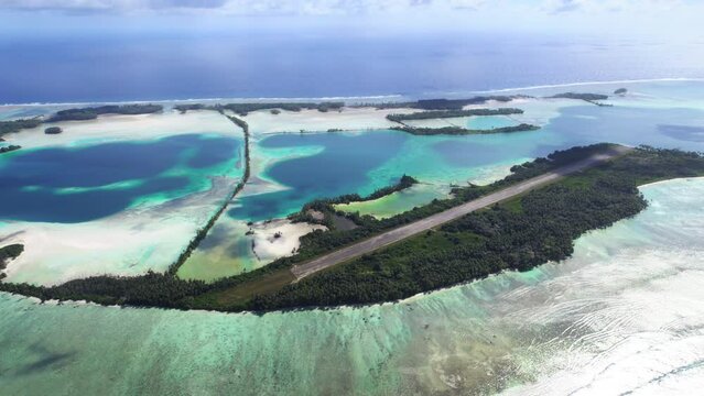Aerial shot of man-made islands, runway, causeways and lagoon at Palmyra Atoll.