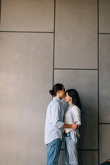 Full length of young couple sitting on stairs in house