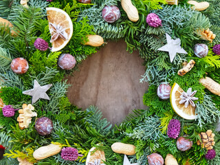 Advent or Christmas arrangement with decoration from nature apples nuts