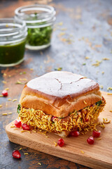Daabeli Vada Pav isolated on wooden board side view of indian food