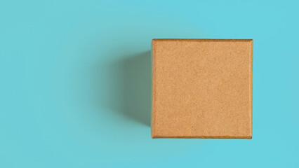 Brown craft paper or carton box with lid mock up on blue background.