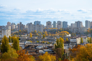 Fototapeta premium City building. Multi-storey residential building. Panorama of autumn Kyiv, the capital of Ukraine. View overlooking the town.