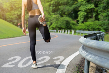 Starting to the new year 2023. Woman a runner waiting to start the new year 2023.Planning,...