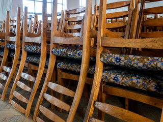 Wooden chairs warehouse. Stacked wooden classic chairs