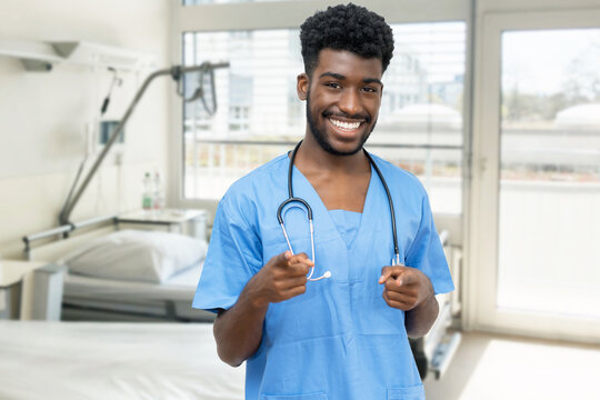Motivated african american young doctor or male nurse at hospital room
