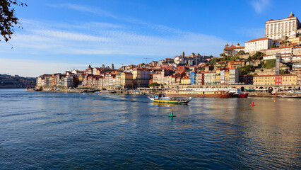 Fototapeta na wymiar Placed along the Douro river and extending with it until the Atlantic ocean, Oporto is a wonderful town. Ribeira do Porto is one of its oldest zones with interesting bridges and colourful buildings