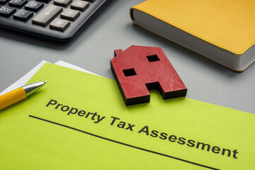 Property tax assessment papers and model of house.