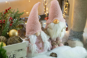Christmas decoration. A Christmas shop window with a pair of dwarfs in pink hats.