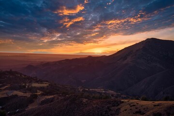 View of mountain slopes - geological formations under the cloudy sunset sky