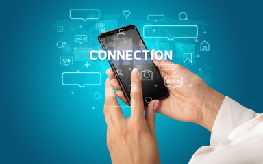 Hand using smartphone with social media concept