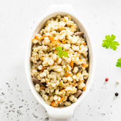 Barley with vegetables and chicken. Top view, copy space, flat lay.