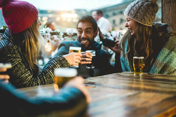 Adult people having fun drinking beer at pub restaurant - Focus on right girl face