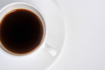 White cup with coffee on white