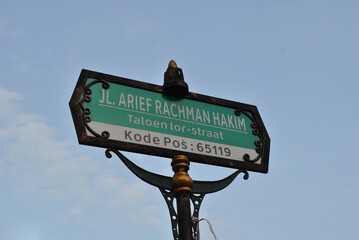 A street name in Malang city with a vintage decorated signpost that means Arief Rachman Hakim Street with zipcode of 65119