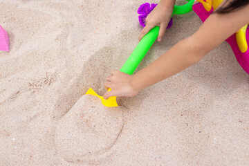 Fototapeta na wymiar Children playing in the sand near the beach.