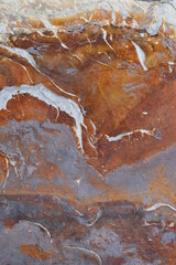 Fondo con detalle y textura de superficie de piedra en tonos marrones y grises, con vetas de color blanco