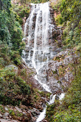 Fototapeta na wymiar Beautiful waterfall in Batu Caves sacral place in Kuala Lumpur, Southeast Asia. Malaysia. 