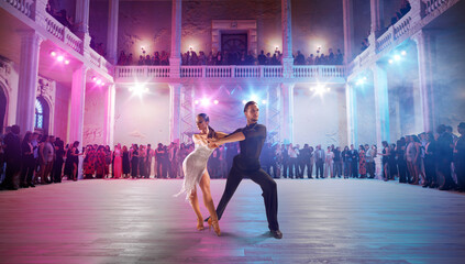 Couple dancers  perform latin dance on large professional stage. Ballroom dancing.