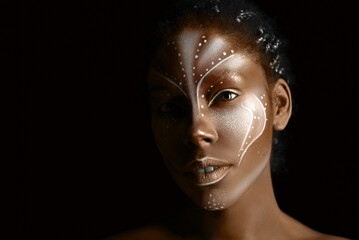 Art photo of Africal woman with tribal ethnic paintings on her face