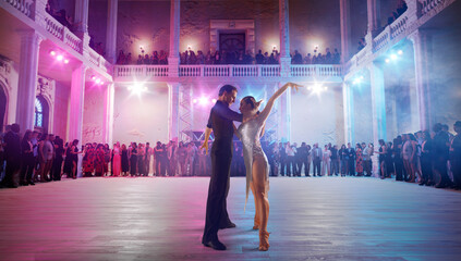 Couple dancers  perform latin dance on large professional stage. Ballroom dancing.