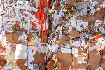 stack of collected old waste paper in front of recycling facility