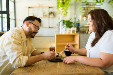 Profile of a boyfriend and girlfriend sharing a coffee on a date