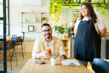 Happy customer receiving his food at the cafe