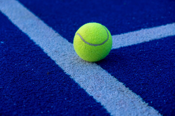 selective focus, a ball on an artificial grass paddle tennis court