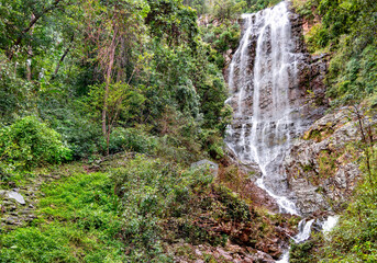 Fototapeta na wymiar Beautiful waterfall in Batu Caves sacral place in Kuala Lumpur, Southeast Asia. Malaysia.