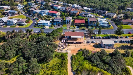 Aerial shot over houses and neighborhood in australia © Revenire/Wirestock Creators
