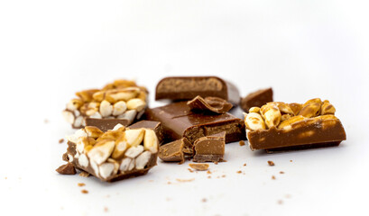 pieces of rice and filled coholate . Broken pieces over white background