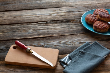 Grilled juicy cutlets in a dish on a wooden table. Grill, barbecue