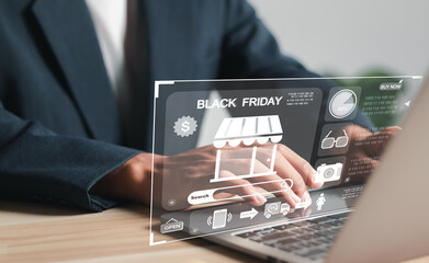 Black Friday sign on virtual screen. Businessman using laptop to shopping via internet at home.