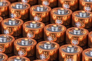 Rows od alkaline battery size AA with positive ends