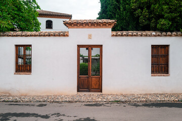 A rustic door in a latin village architecture style, that could be from Europe or America,...