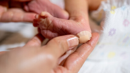 Obraz na płótnie Canvas Newborn heel prick test and lood puncture, Taking a Heel Blood Sample From Newborn Baby