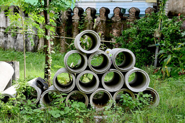 BANGKOK, THAILAND - November 22, 2022 : Concrete drainage pipe lined up in the forest on the side...