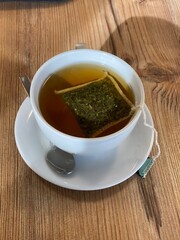 green tea in the cup on a wooden background. top view
