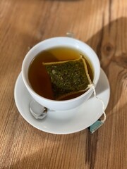 green tea in the cup on a wooden background. top view