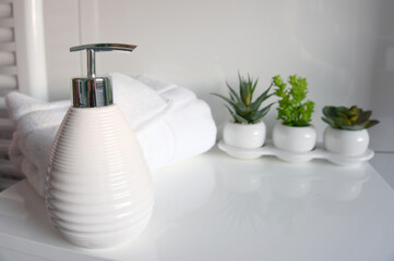 cosmetic shampoo and towel on the table in the bathroom