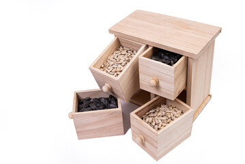 Wooden box cells filled with various spices. wooden box with sunflower seeds, peeled and raw