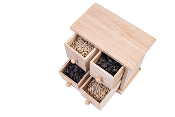 Wooden box cells filled with various spices. wooden box with sunflower seeds, peeled and raw