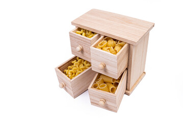 Different types of italian uncooked pasta in wooden box, whole wheat pasta, pasta, spaghetti, noodles, tagliatelle. Top view