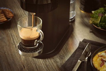 Close-up of making coffee in a capsule coffee machine.