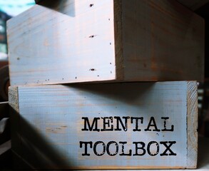 Wood box with text inscription written MENTAL TOOLBOX, refers to various tools to tackle different...