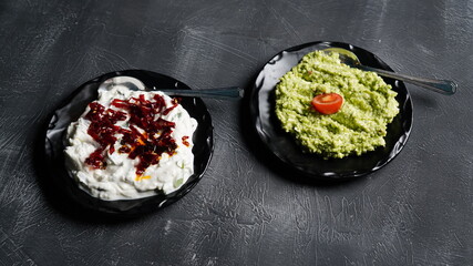 two kinds of appetizers on black background