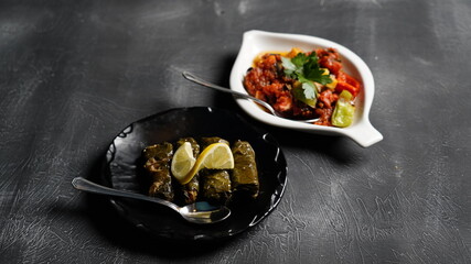 sarma and appetizer presentation on black background