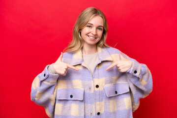 Young English woman isolated on red background proud and self-satisfied